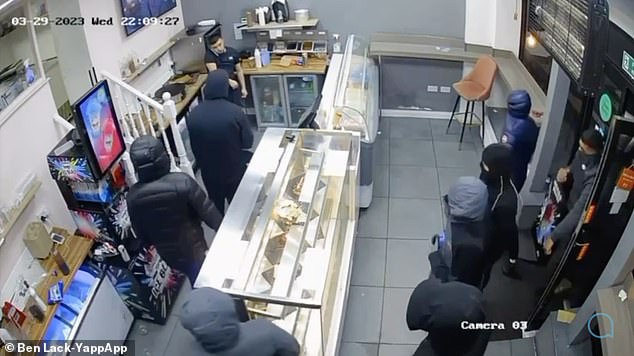 Shocking moment cake shop worker attacked by group of eight men before one throws desserts at victim