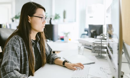 Portrait of young Asian graphic designer working with computer in the studio