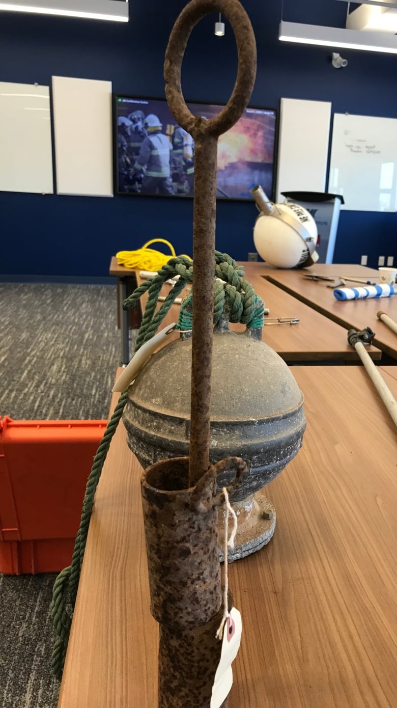 A rusty piece of equipment sits on a table.