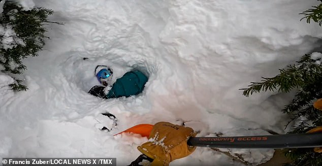 He's able to get himself out but then he quickly puts the brakes on before departing when he sees a snowboard sticking out of the deep snow