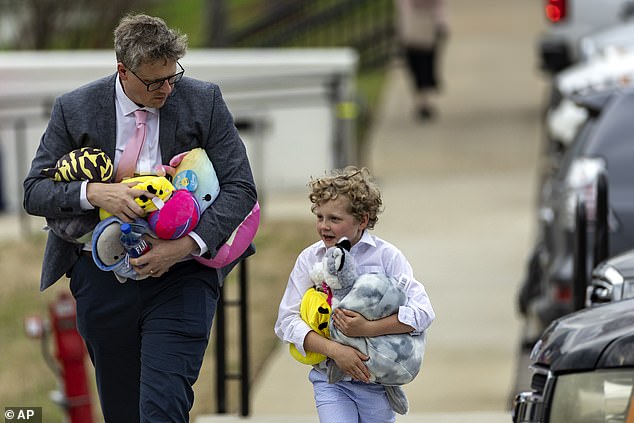 Others brought stuffed animals to the service which was held at Woodmount Christian Church - less than three miles from the site of the attack