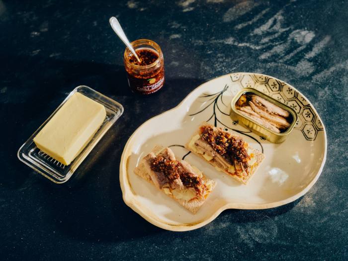 Sardines on crackers with Momofuku chilli crunch and Kerrygold butter