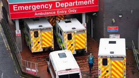 Ambulances wait to unload patients at the A&E department at Glasgow Royal Infirmary