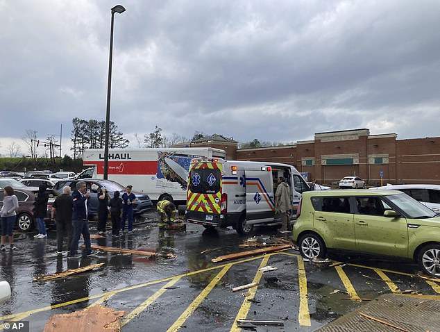 Emergency personnel checked people in a parking lot after severe storm swept through