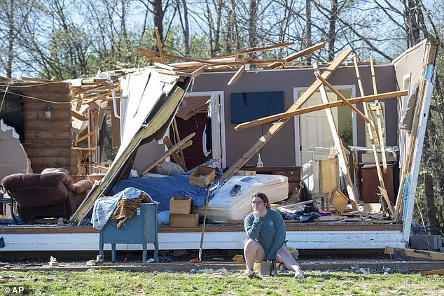 Regan Millmeyer sits in front of her tornado damaged home in Adamsville, Tennessee