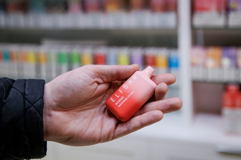 The CBC’s Adam Miller holds an Elf Bar vaping device at a downtown Toronto vape shop on April 25, 2023.