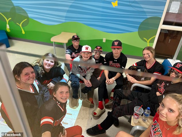 The boys and girls' teams sat in the hospital waiting room to show support while their parents and teammates received treatment