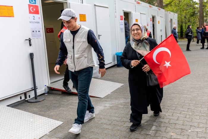 A man and a woman leaving the Turkish consulate