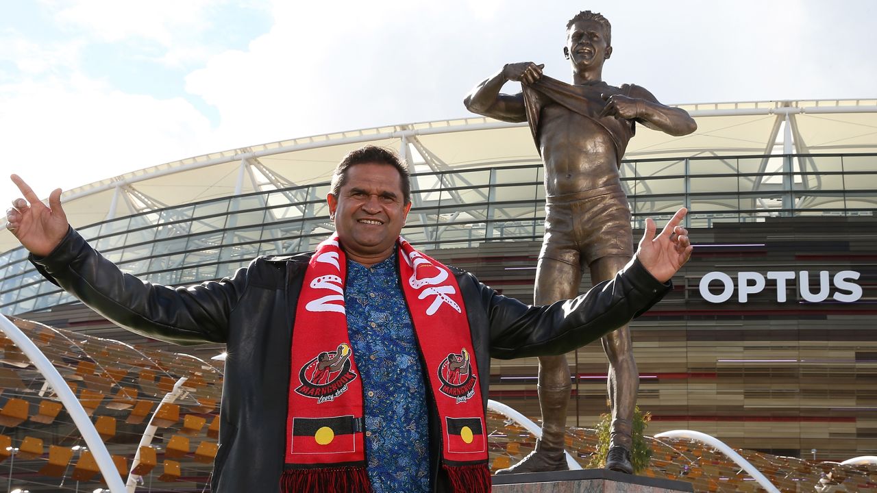 Nicky Winmar poses with his statue in Perth, Australia, in 2019. 