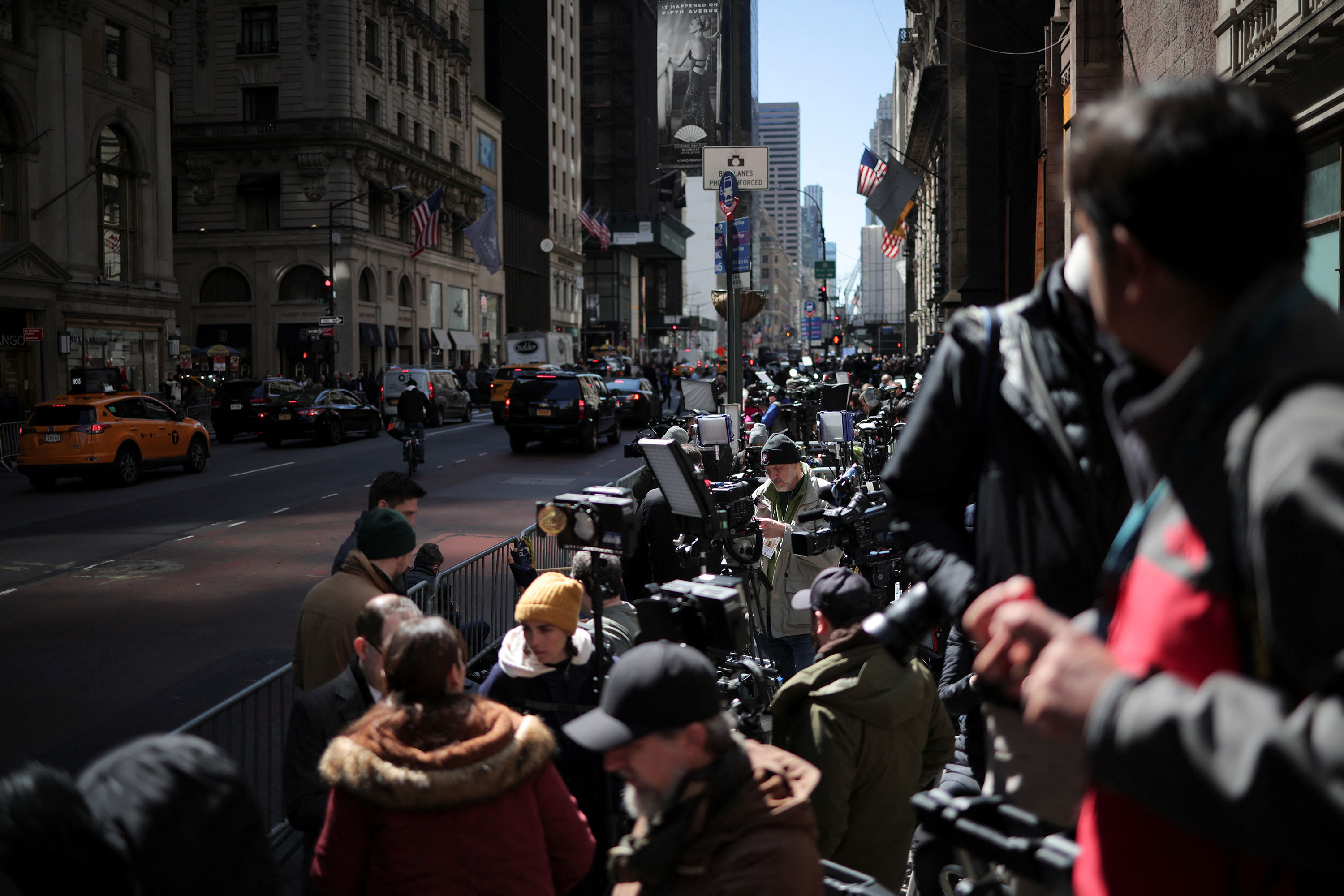 Members of the media are seen positioned outside Trump Tower in New York on Monday.