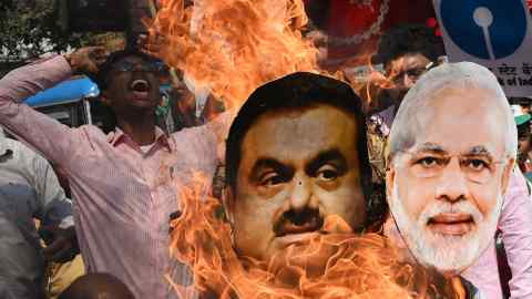 An effigy of Gautam Adani and PM Narendra Modi is burned during a protest