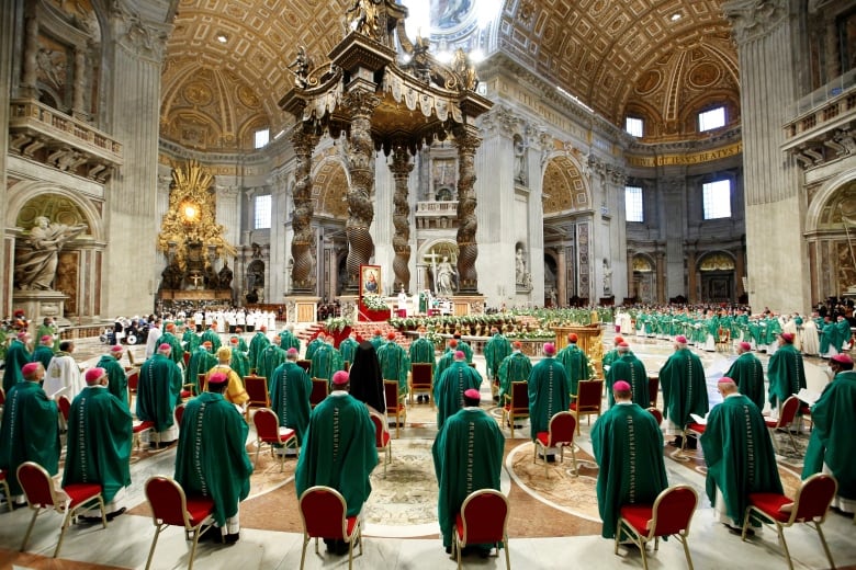 The pope leads bishops in mass inside a church.