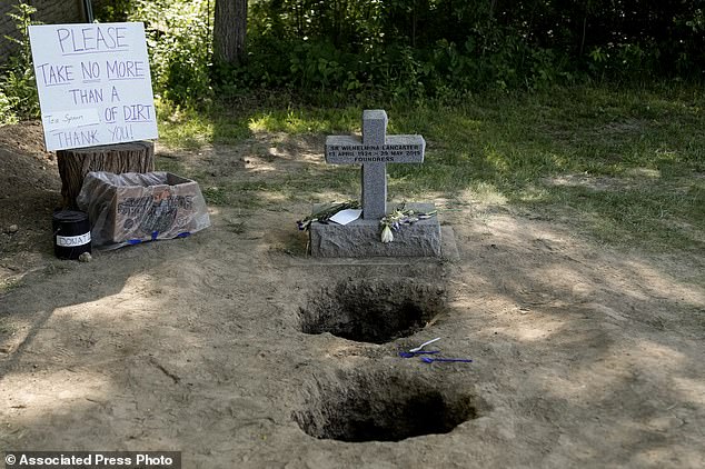 People collected dirt from the gravesite of Sister Wilhelmina Lancaster at the Benedictines of Mary, Queen of Apostles abbey on Sunday