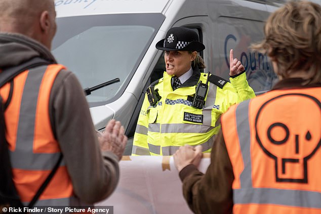 Another police officer seen speaking to the activists