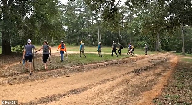 Searchers are seen canvasing the woods near the couple's home, which stretches for several thousand square acres