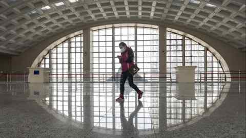 A woman walks in a train station in China