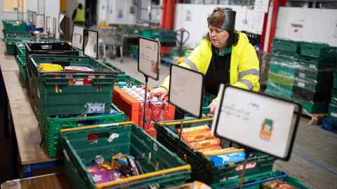 A woman works at a food bank distribution centre in Coventry. Volunteers and staff have risen to every challenge, but many are weary to the bone