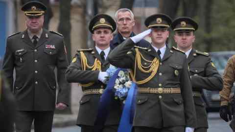 Nato secretary-general Jens Stoltenberg with Ukrainian soldiers in Kyiv. Capitalised by allies, a Nato bank would offer lower rates for defence investment and allow for long-term stable financing