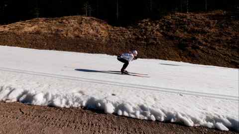 A skier on a strip of artificial snow