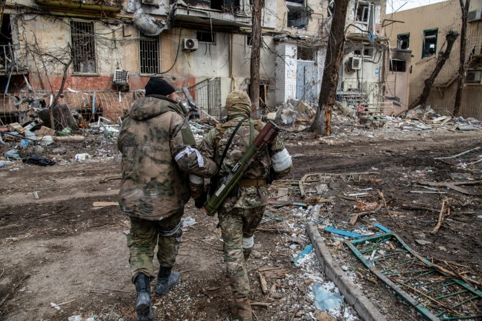 Russian and Chechen soldiers in a devastated Mariupol neighborhood