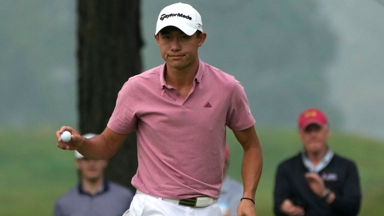 Collin Morikawa acknowledges the fans after his putt on the third green during the first round of the 2023 Rocket Mortgage Classic golf tournament at Detroit Country Club