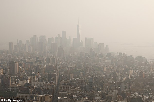 Smoke from wildfires in Canada shrouds lower Manhattan and One World Trade Center in a view seen from the 86th floor of the Empire State Building