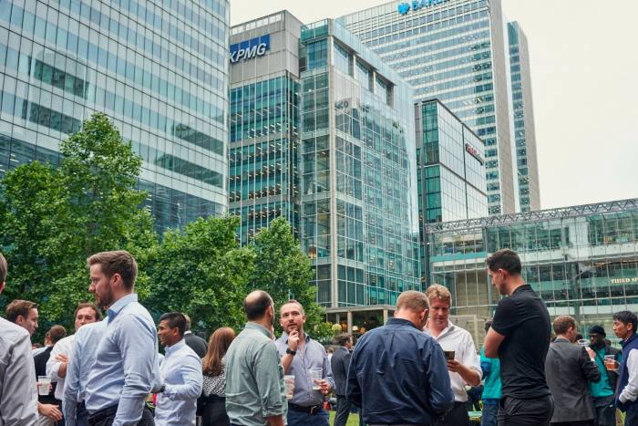 Office workers socialising outside Canary Wharf buildings