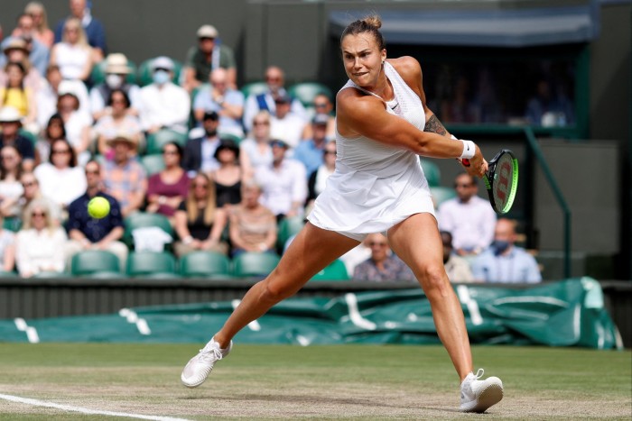 Aryna Sabalenka reaches to her left to take a shot