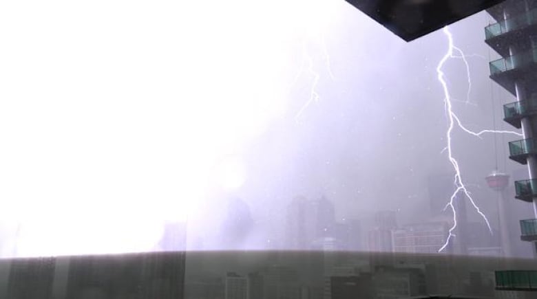 A lightning bolt strikes in front of the Calgary tower. 