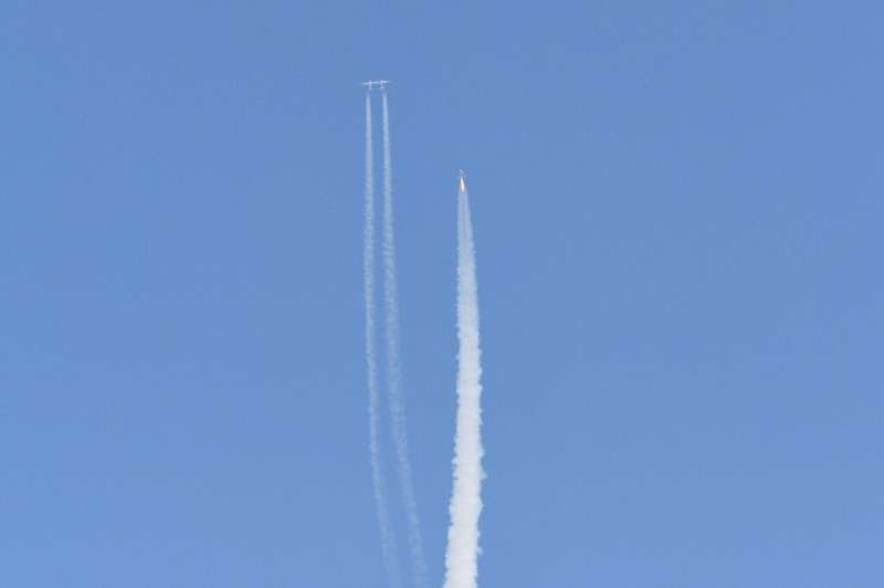 The Virgin Galactic SpaceShipTwo space plane Unity and mothership separate as they fly way above Spaceport America in New Mexico