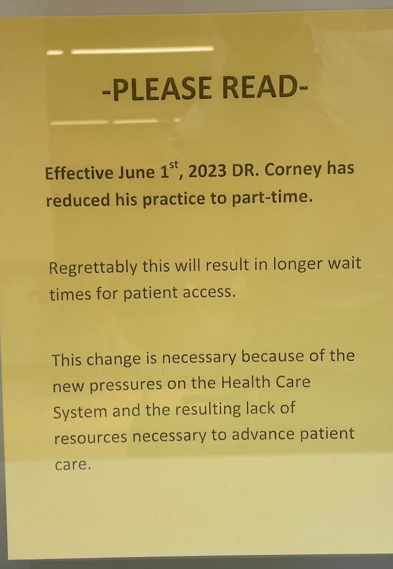 A yellow sign is shown outside Dr. Paul Corney's office, notifying patients he's reduced his practice to part-time.  