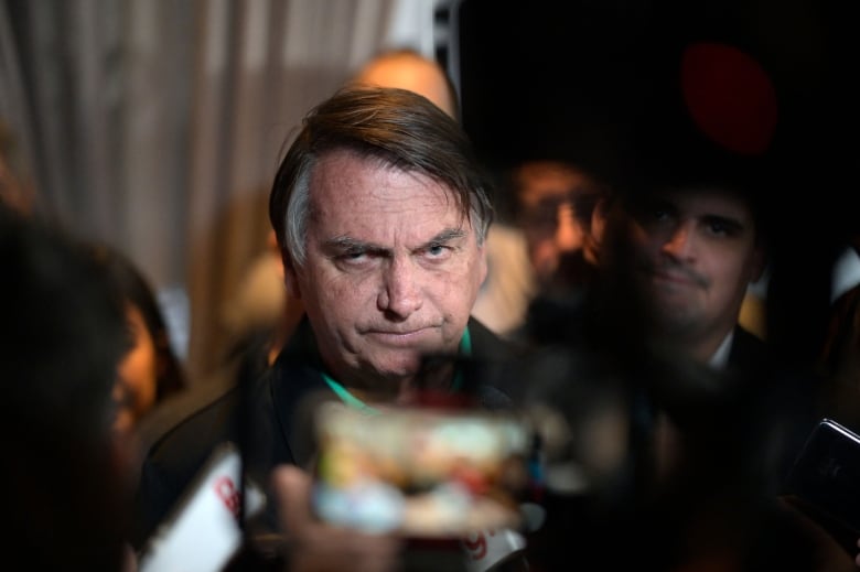 Former Brazilian president Jair Bolsonaro is seen speaking to members of the media in Horizonte in Brazil's Minas Gerais state.