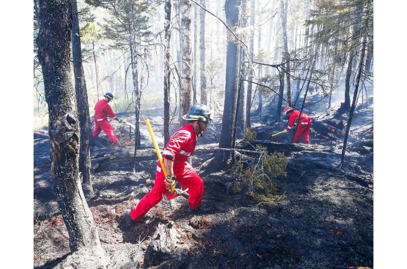 Firefighters with Halifax Regional Fire and Emergency work to put out fires in the Tantallon area of Nova Scotia