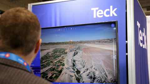 A visitor looks at a presentation by Teck