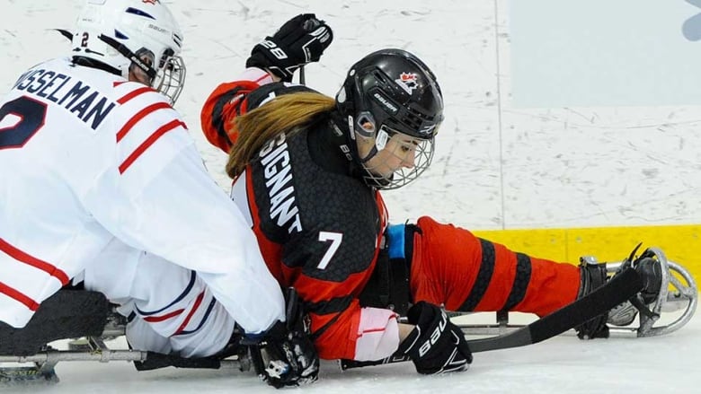 Canadian woman, right, competes in Para hockey against team U.S.A.