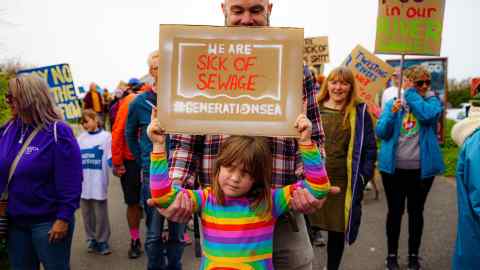 Campaigners take part in a day of action against sewage pollution coordinated by Surfers Against Sewage in Newquay, Cornwall