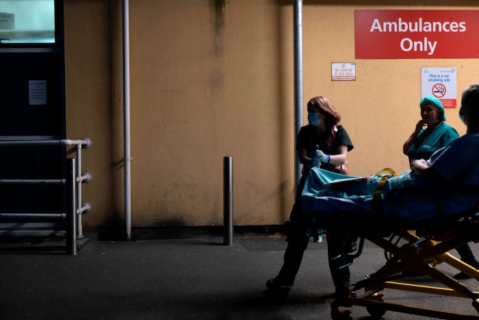 Nurses wheel a patient into the hospital