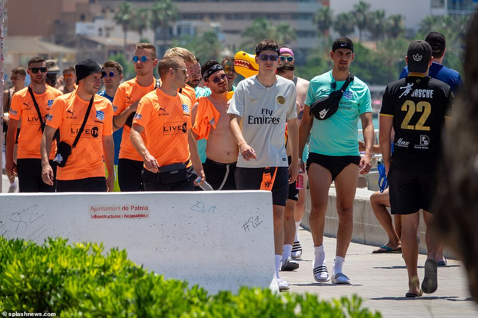 Other tourists lived it up in flourescent sports tops as they toured the beach-town's promenade