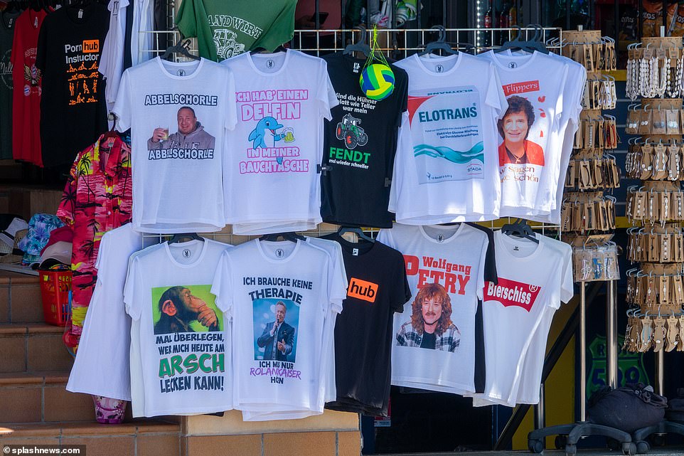 Joke t-shirts line the shop fronts to tempt boozy Germans to make a dodgy purchase