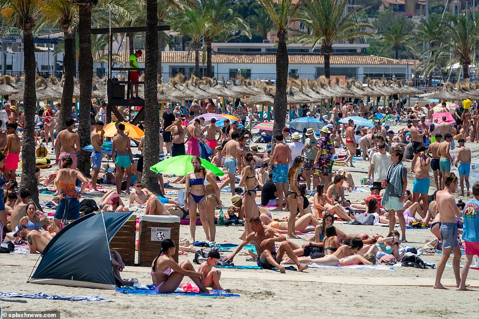 Punters packed the sunny beaches as tropical umbrellas provide shade in ordered lines