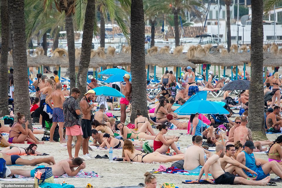 Scantily clad tourists flock to the beaches under the tropical palms as they enjoy their Mediterranean holiday