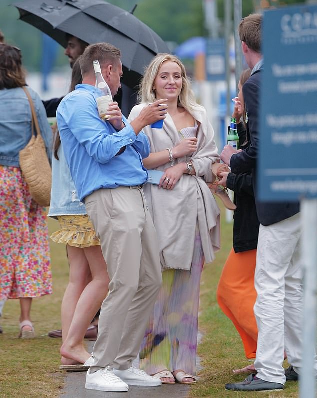 A stylish couple pictured enjoying their bottle of wine in the afternoon