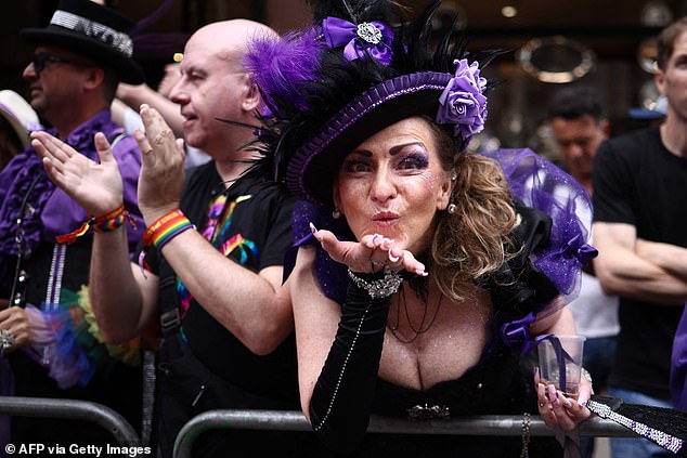 Crowds clap and cheer as the parade heads through London