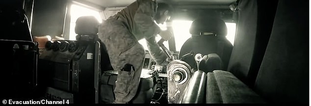 A military vehicle is destroyed as a soldier whacks its dashboard and controls and abandoned helicopters lie in sheds with their engines open and debris lying around them