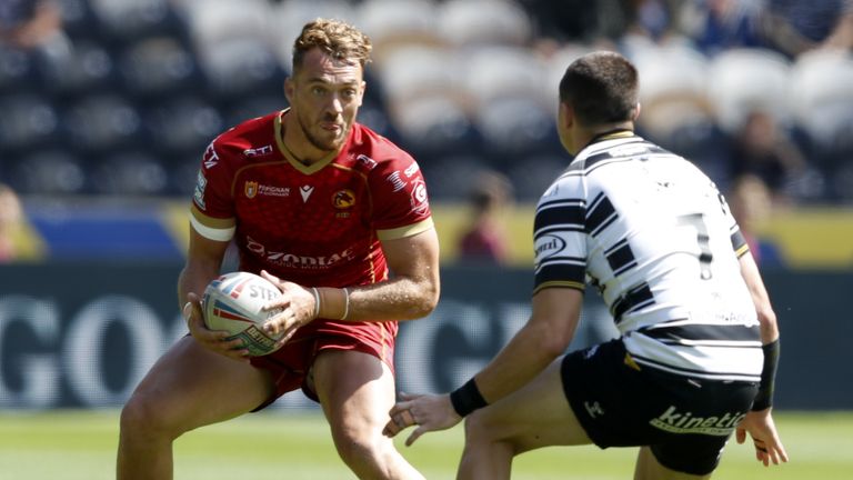 Catalans Dragons' Paul Seguier (L) takes on Jake Clifford of Hull FC