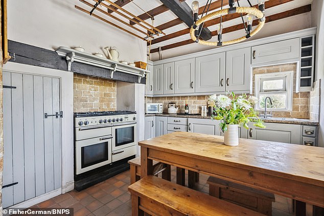 The original beams remain in place in the kitchen, which has maintained some of its older and quirkier features