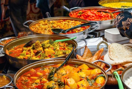 Variety of cooked curries on display at Camden Market in London