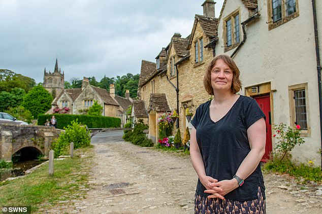 Georgina Kingshott, 44, (pictured outside her home) has lived in Castle Combe since 2016. She claims tourists have been invading her privacy by flying drones over her home despite 'signs up and down' the area forbidding the practice