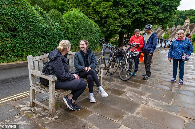 Ms Roberts claims that when she first moved to Castle Combe around 95 per cent of the village was filled with residents. People are pictured in the village