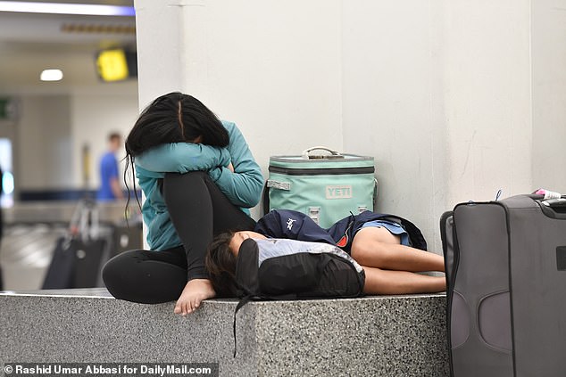 A passengers is seen waiting for their bags to arrive at the baggage claim at Newark